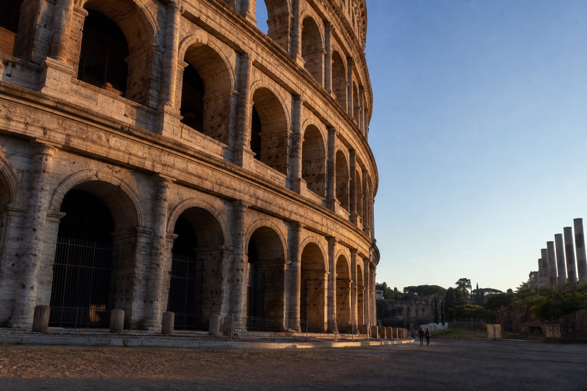The Colosseum lit by early-morning sun, seen from the Oppian Hill among the top sights in Rome