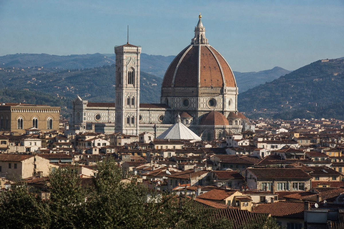 Florence's Duomo and Brunelleschi's dome above the terracotta rooftops on the Rome Florence Venice train itinerary