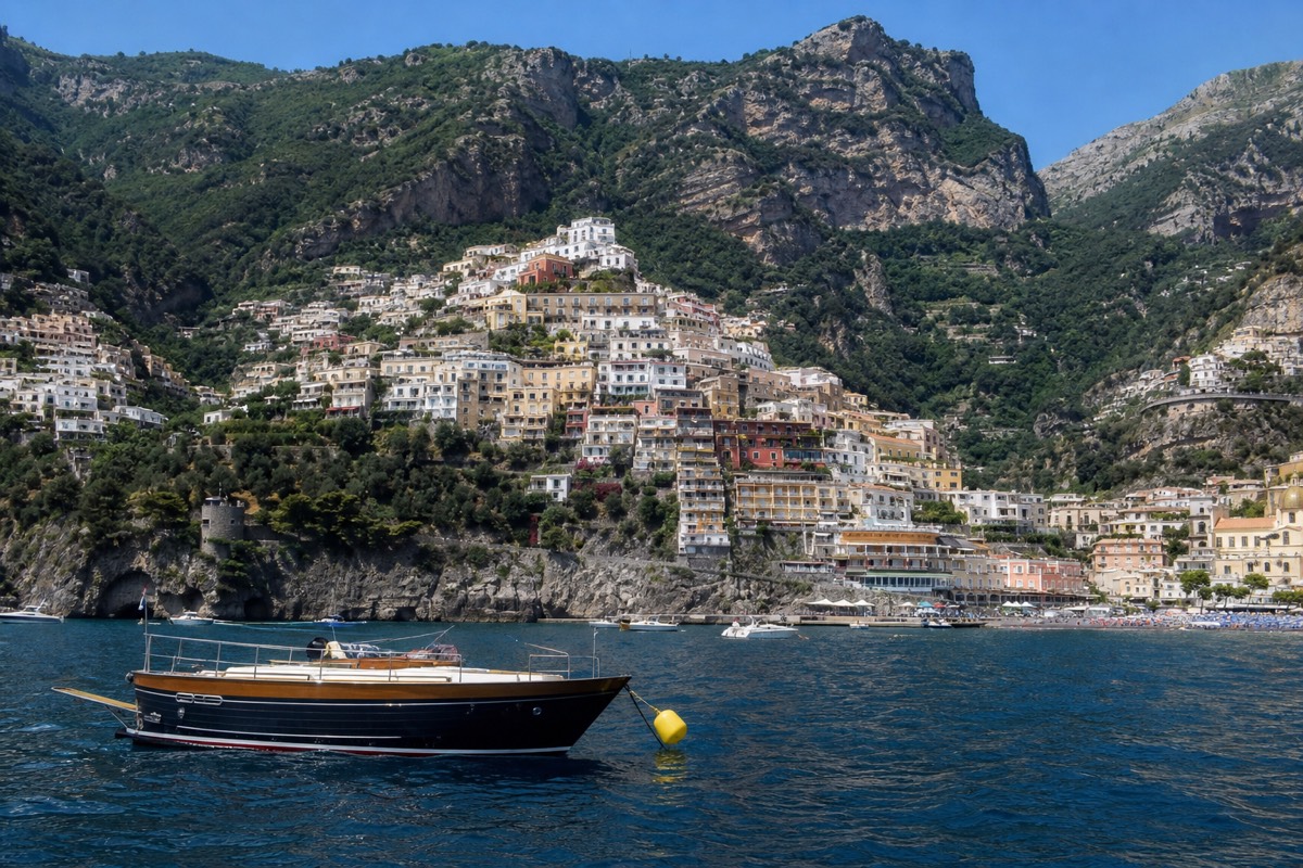 Tours from Rome to the Amalfi Coast show Positano's cliffside houses seen from the water